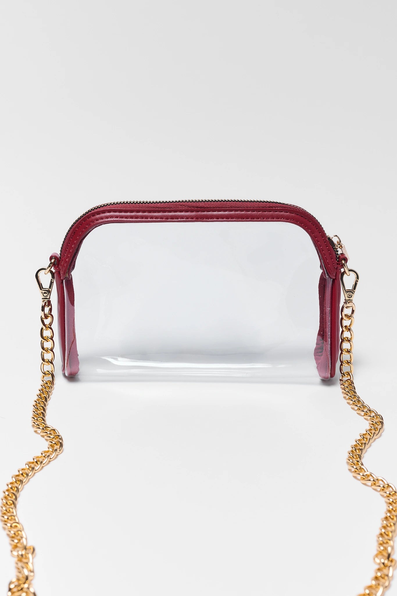 Tas selempang transparan dengan trim maroon dari koleksi MAHIRTOTO