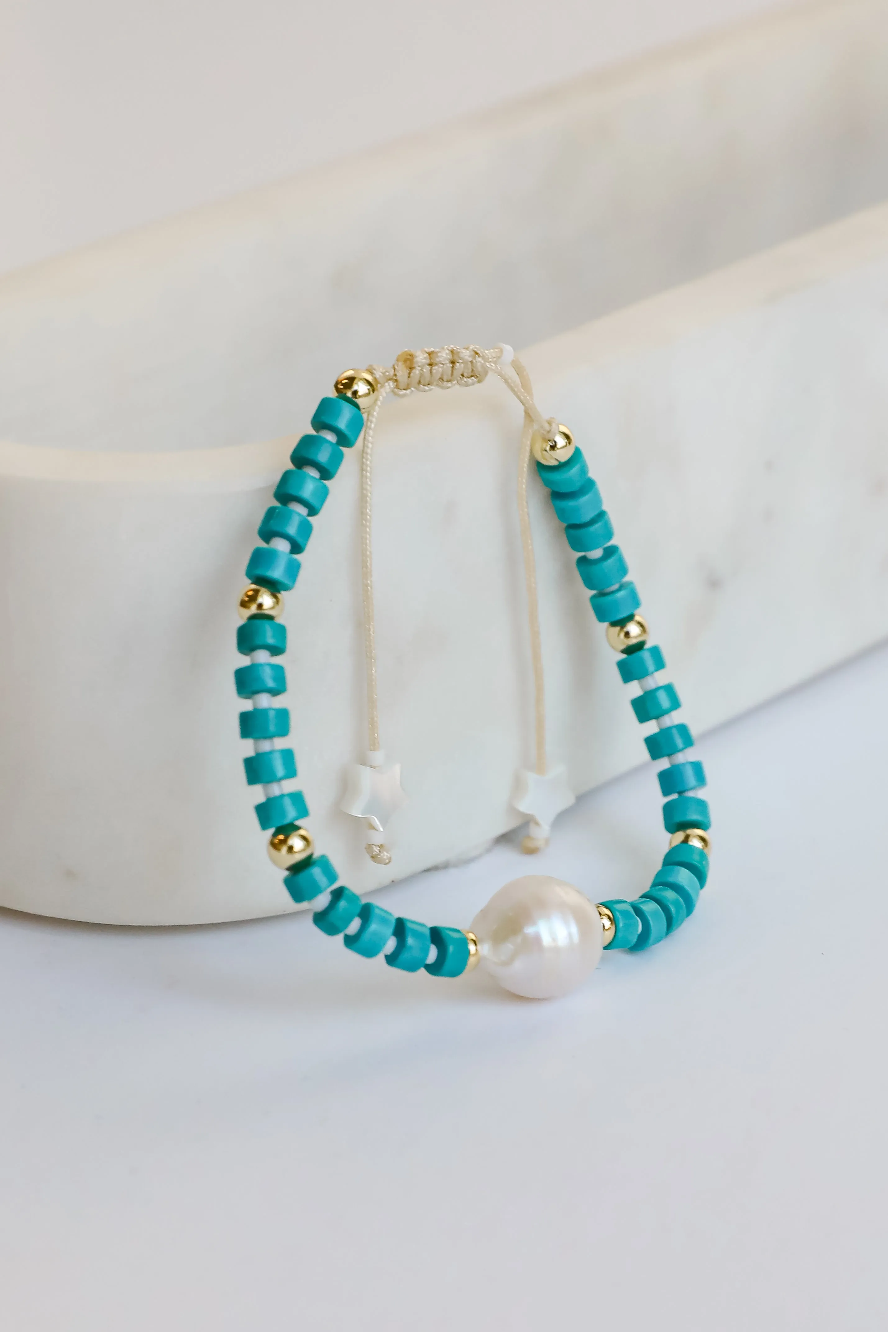 Gelang manik-manik warna teal dengan aksen mutiara dan bintang dari RACUNTOTO